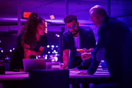 Group of people discussing a project while around a table