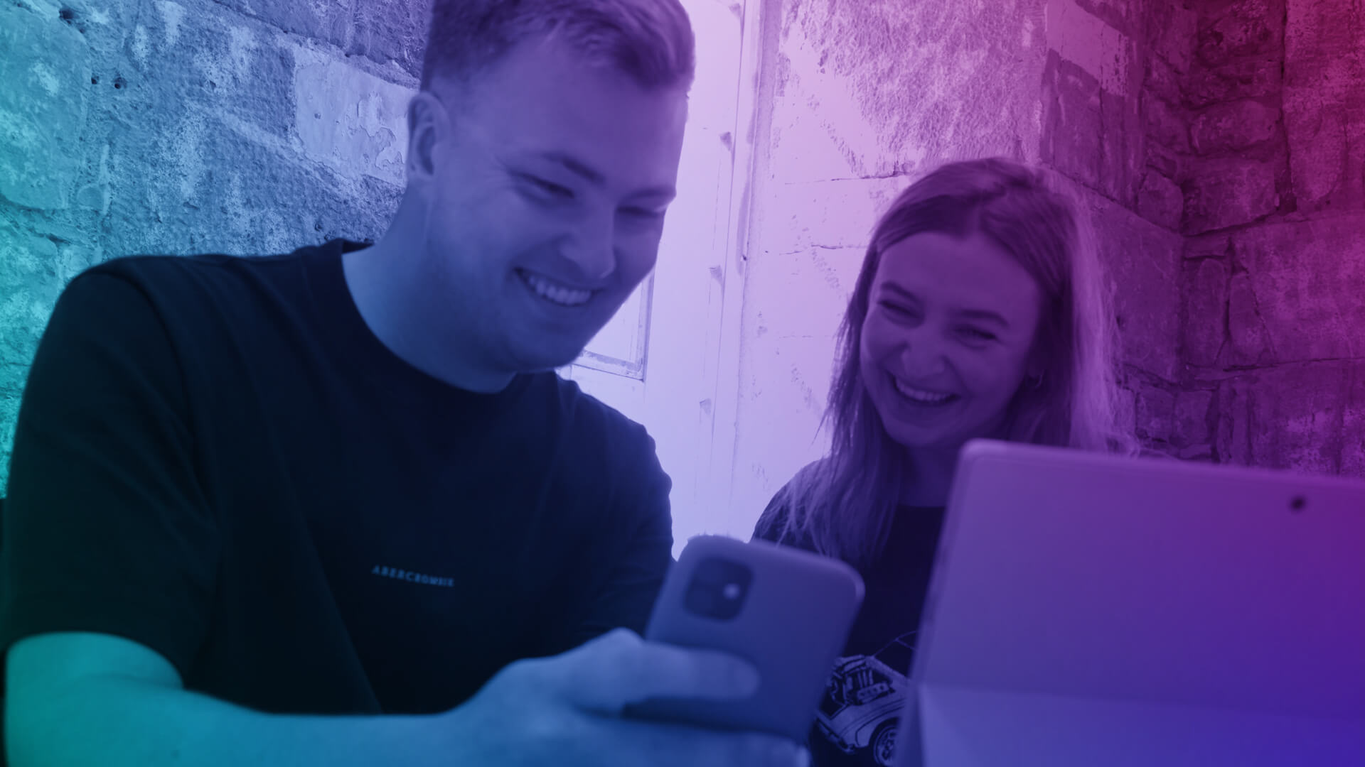 Two people taking part in an in-person & virtual training course