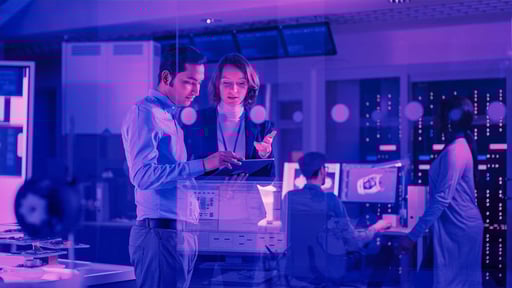 man and woman looking at tablet