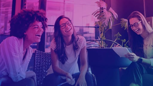 Three women laughing together